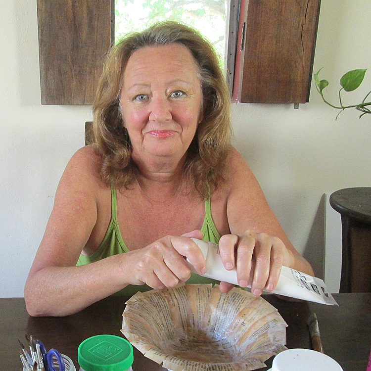 woman making a paper mache bowl