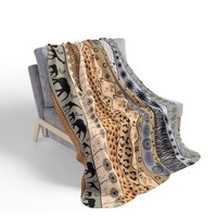 Neutral African Art Fleece Blanket on a chair