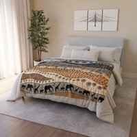 Small neutral African Art Fleece Blanket on a bed