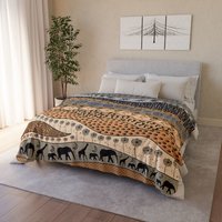 Large neutral African Art Fleece Blanket on a bed