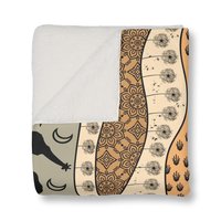 Folded Neutral African Art Fleece Blanket showing fleece side
