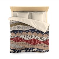Queen duvet cover. Naive African elephants and giraffes artwork with primitive floral motifs in maroon, navy blue and earth tones.