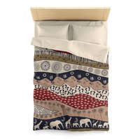 Twin duvet cover. Naive African elephants and giraffes artwork with primitive floral motifs in maroon, navy blue and earth tones.