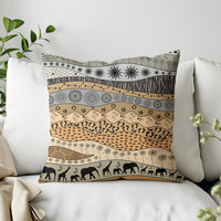 Throw pillow with naive tribal art of elephants and giraffes and primitive motifs in earth tones.