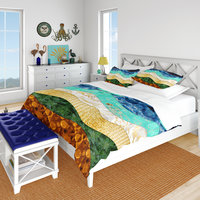 The queen duvet cover features a layered, wavy design resembling the view out to sea from the beach edge.