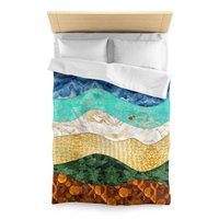 The twin duvet cover features a layered, wavy design resembling the view out to sea from the beach edge.