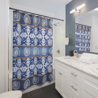 Blue Seashell Shower Curtain hung in a small bathroom