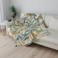 Small Watercolor Leaves Fleece Blanket on a couch