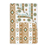 Aztec art printed on a lightweight, soft and fluffy two-sided reversible plush velveteen throw blanket in white, light teal, tan, and brown. One side is printed on a white background and the other side is printed on a tan background.