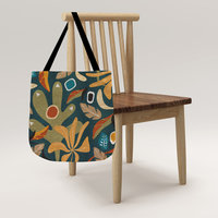 Multicolor Abstract Floral Woven Tote hanging on a chair.