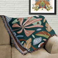 Bold Modern Floral Woven Cotton Blanket folded on a couch