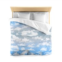 Queen duvet cover printed with fluffy white clouds on a blue and gray ombré sky background.