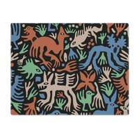 Placemats with Cute folk art of otherworldly dinosaurs, flora and fauna in brown, beige, green and blue on a black background.