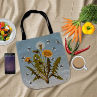 Flat lay Dandelions and Bees Woven Tapestry Bag surrounded by vegetables, a bowl of jelly beans and a cell phone.