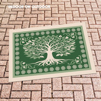 Celtic Tree of Life Rug in green and beige on patio stones