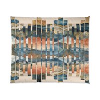 King comforter. This design features a geometric, abstract landscape pattern composed of vertical strips that create a fragmented, kaleidoscopic effect. The color palette blends earthy tones of rust, beige, and ochre, with cool blues and muted greens, evoking a stylized horizon or mountain range reflected in water.