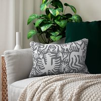 Lumbar pillow, Primitive white hand-drawn animals and plant life. One side is printed on a gray background.