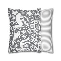 Pillowcase. Primitive white hand-drawn animals and plant life. Printed on a gray background.