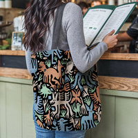 Whimsical Animals Woven Tote, Folk Art Tapestry Bag hanging from the shoulder of a girl at a restaurant counter.