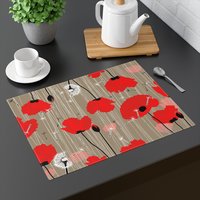 Bold red poppies placemat on a gray table