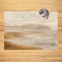Neutral area rug with an abstract coastal haze design in taupe, beige, and soft grey tones, styled on a wood floor with a cat resting at the corner.