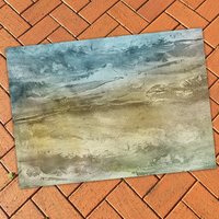 Sandy Ocean Beach Rug on a brick patio floor