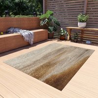 Neutral area rug with an abstract coastal haze design in taupe, beige, and soft grey tones styled in a back yard space.