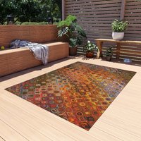 Colorful Boho Rug – Orange Mosaic Pattern with Retro Flair in an outdoor setting.
