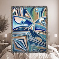 Modern Cubist Woven Blanket – Abstract Art Throw in Blue and Brown styled in a modern bedroom