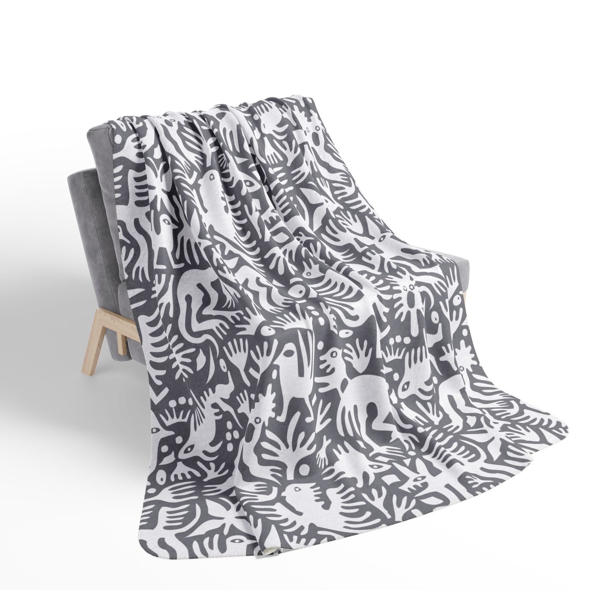 White hand-drawn folk art animals and plants printed on a lightweight, soft and plush two-sided velveteen throw blanket.