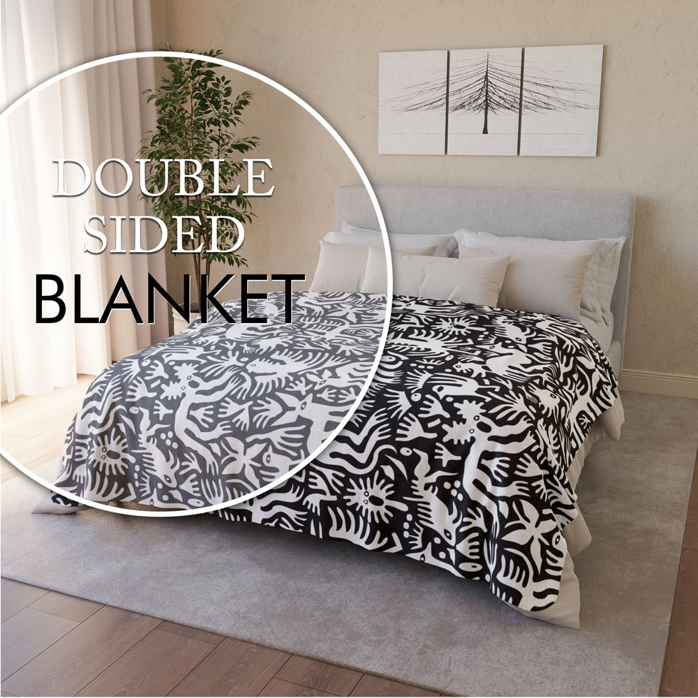 White hand-drawn folk art animals and plants printed on a lightweight, soft and plush two-sided velveteen throw blanket.