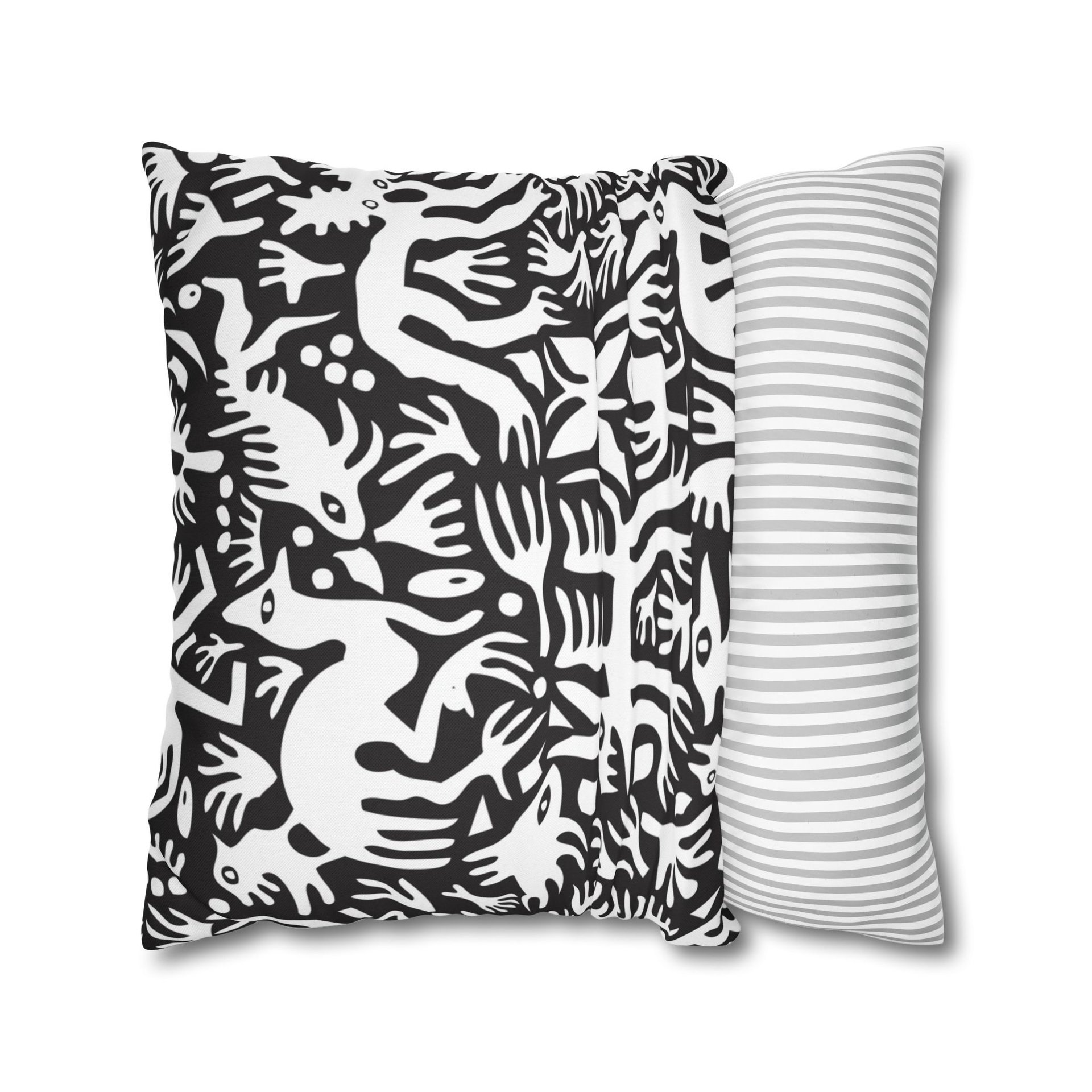 Pillow cover. Primitive white hand-drawn animals and plant life. Printed on a black background.