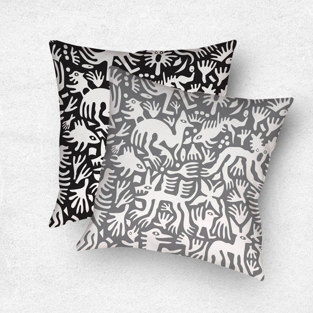 Primitive white hand-drawn animals and plant life. One side is printed on a black background and the other side is printed on a gray background.