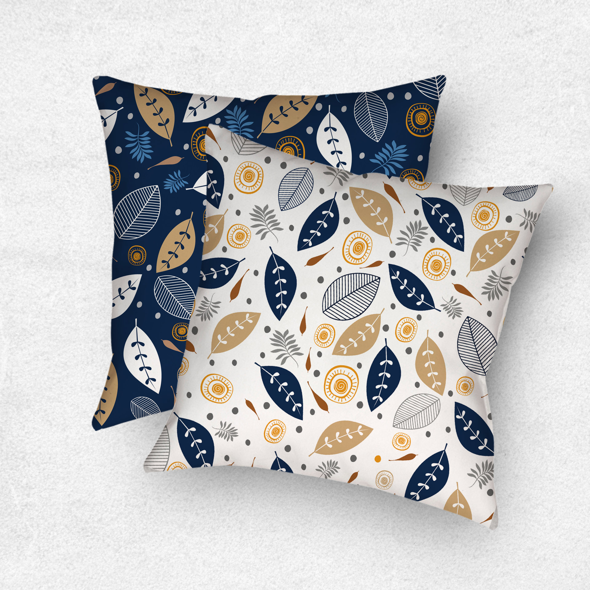 Reversible Pillow. Botanical art in white, navy blue, tan, gray, orange and brown. One side is printed on a white background and the other side is printed on a navy blue background.