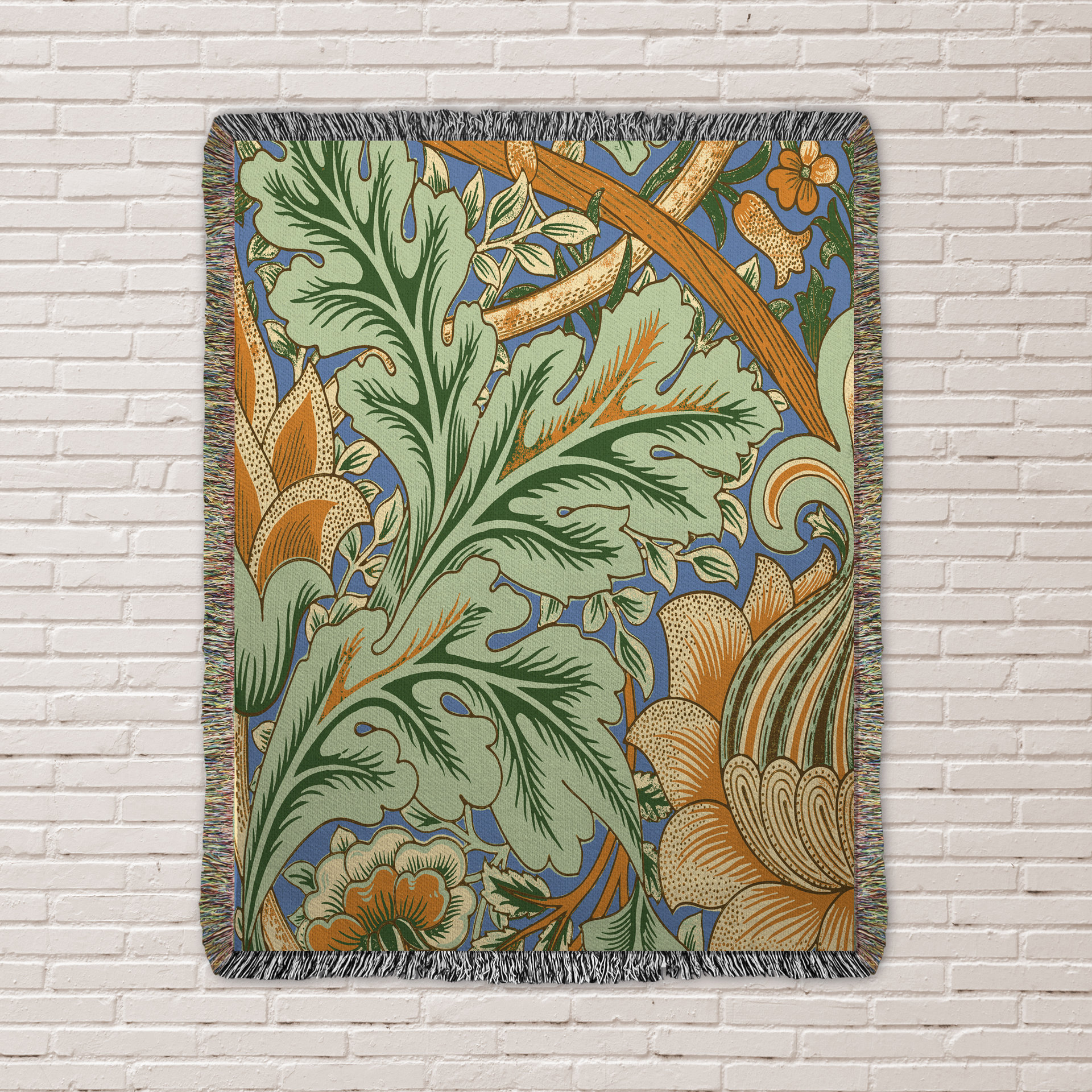 Art Nouveau Floral Blanket - 100% Woven Cotton Fringed Throw hung as a tapestry against a white brick wall.