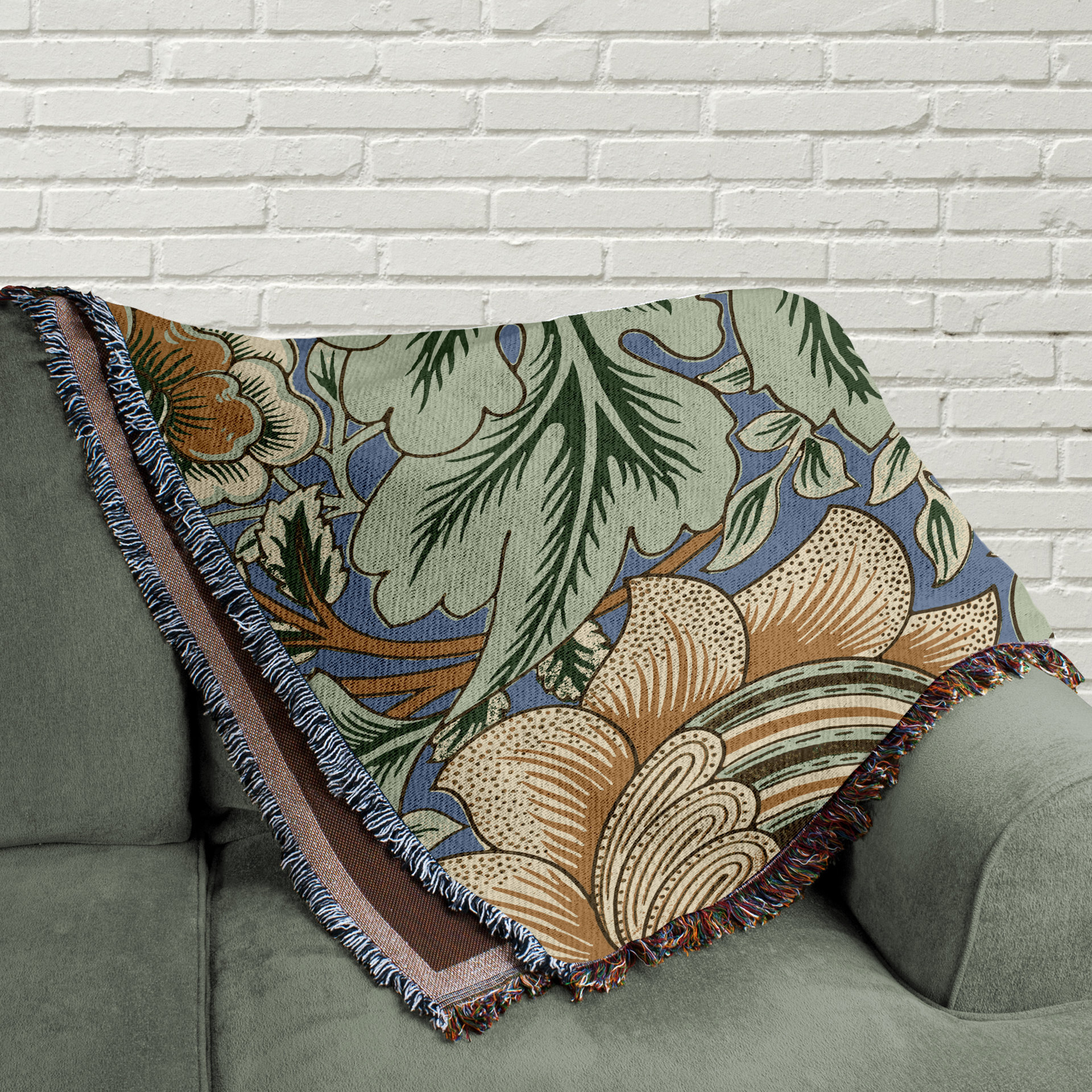 Art Nouveau Floral Blanket - 100% Woven Cotton Fringed Throw folded on a couch.