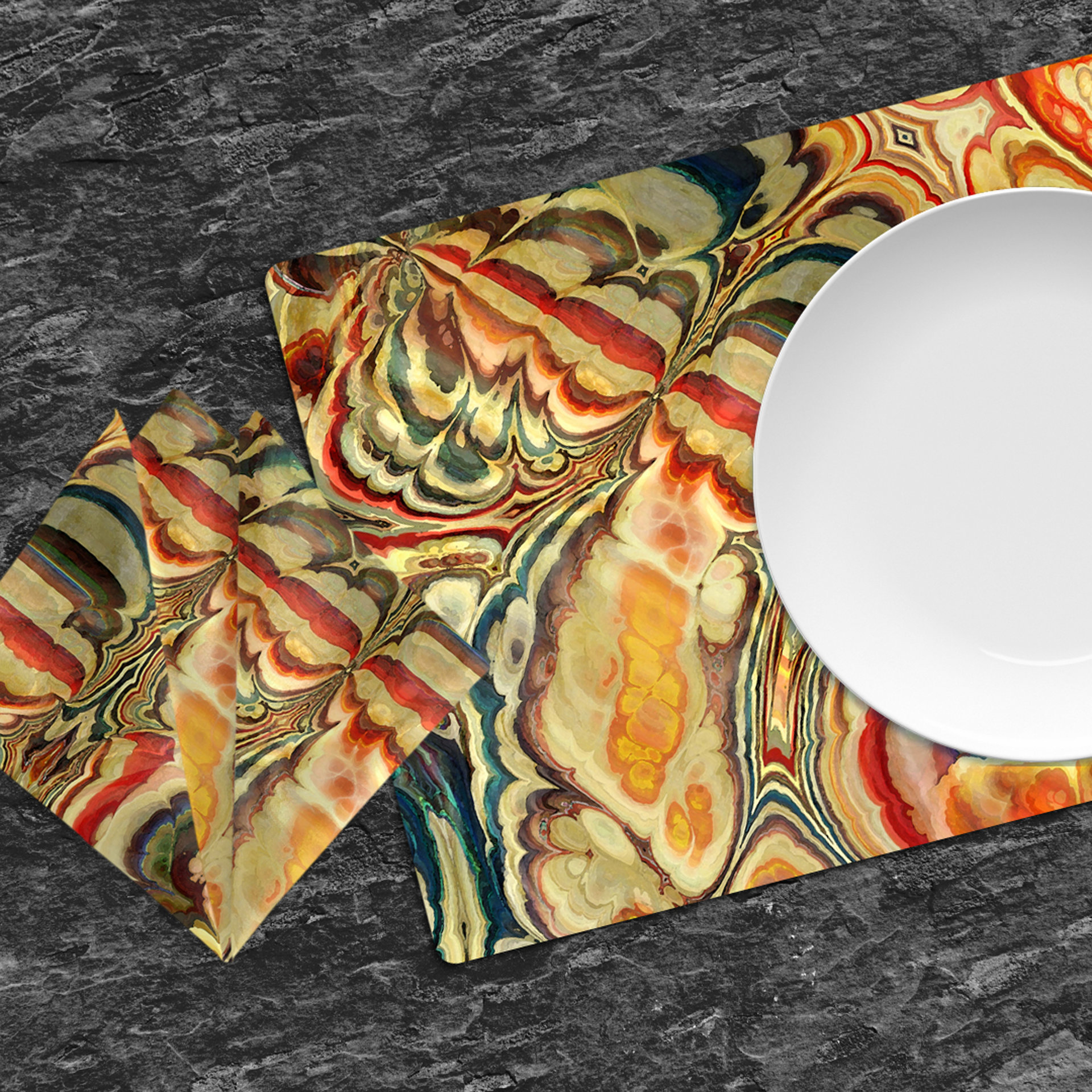 Vintage Parisian style paint pour placemats and napkins on a dark wood table.