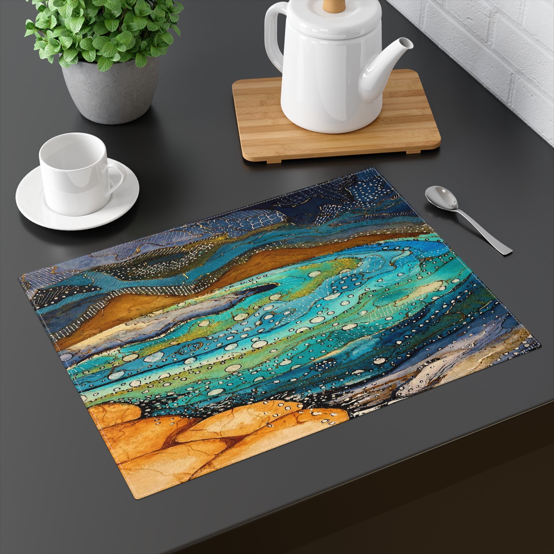 Placemat with a nautical watercolor painting of a tropical island in turquoise, teal and orange with navy blue, sea green, slate gray and beige accents.