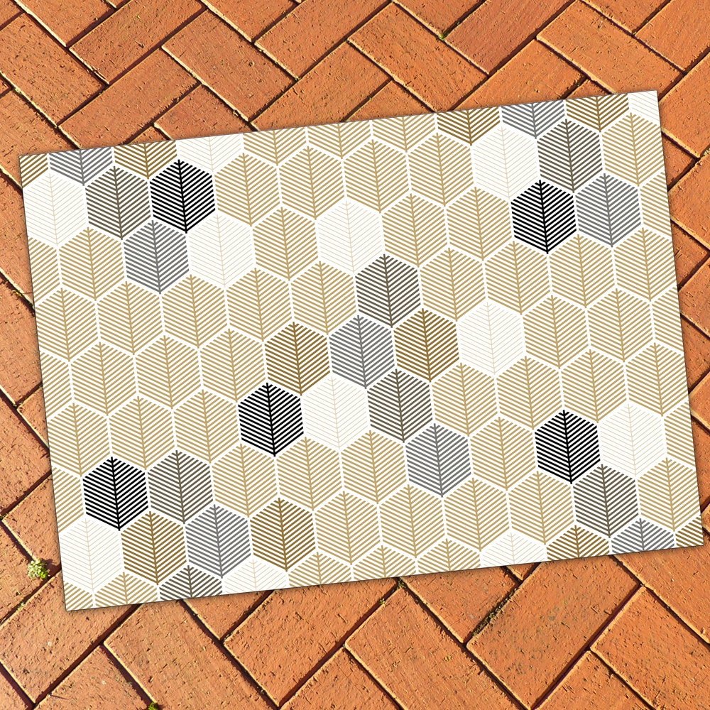 Neutral Geometric Area Rug – Leaf Design Hexagon Pattern on a red brick patio floor.