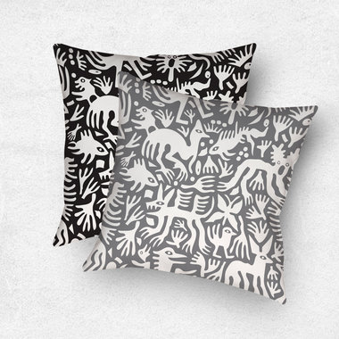 Primitive white hand-drawn animals and plant life. One side is printed on a black background and the other side is printed on a gray background.