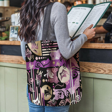 Purple Abstract Geometric shapes Tapestry Bag hanging from the shoulder of a young woman reading a menu at a restaurant counter.